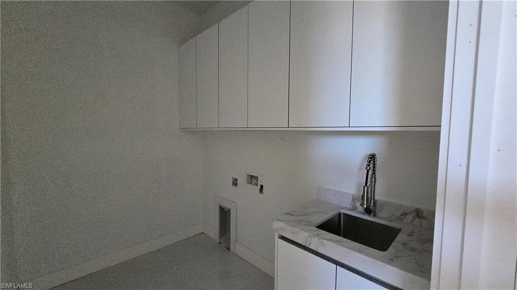 2006 Nelson Road North Cape Coral, FL 33993 - Photo 44 of 50 a kitchen with a sink and cabinets