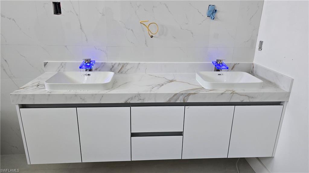 2006 Nelson Road North Cape Coral, FL 33993 - Photo 45 of 50 a bathroom with a sink and a mirror