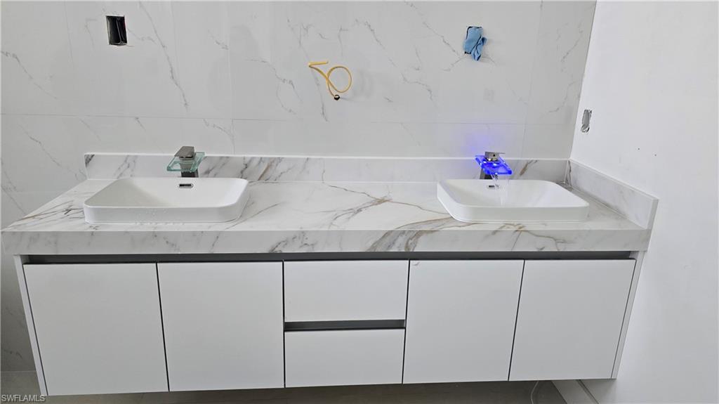 2006 Nelson Road North Cape Coral, FL 33993 - Photo 46 of 50 a bathroom with a sink and a mirror