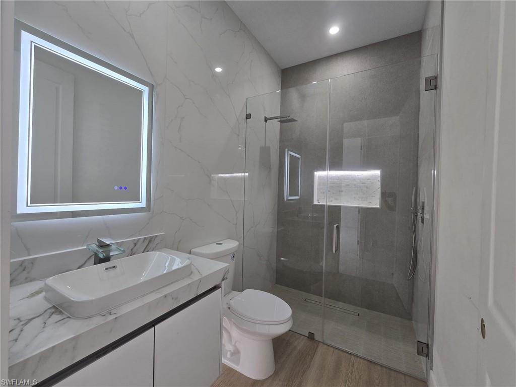 2006 Nelson Road North Cape Coral, FL 33993 - Photo 50 of 50 a bathroom with a granite countertop sink toilet and shower