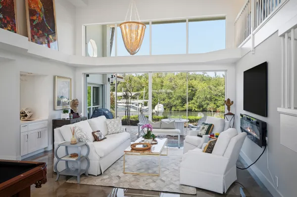 a living room with furniture a rug and a chandelier