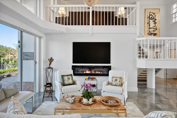 a living room with fireplace furniture and a flat screen tv