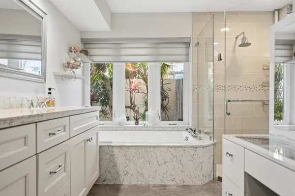 a kitchen with stainless steel appliances kitchen island granite countertop a table chairs and a refrigerator