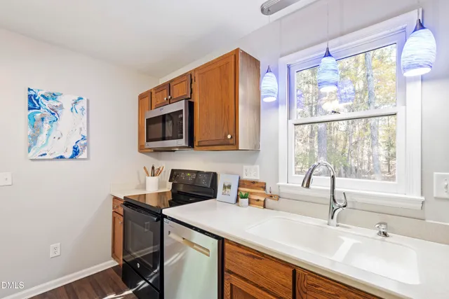 a kitchen with a sink cabinets and a window