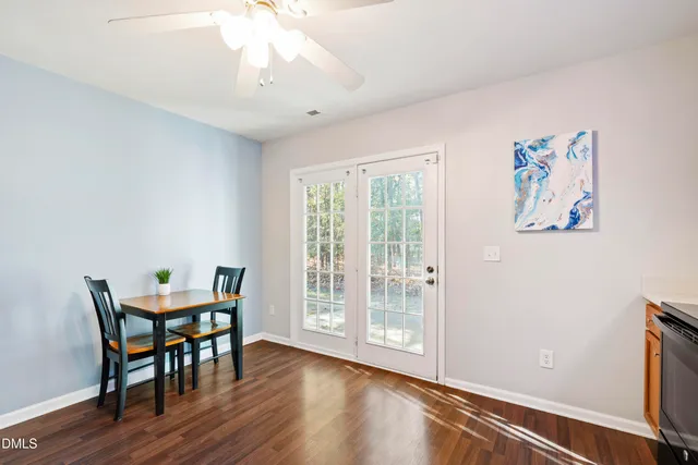 a view of a room with furniture wooden floor and a window