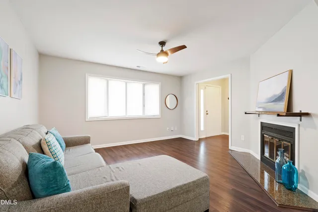 a living room with furniture fireplace and window