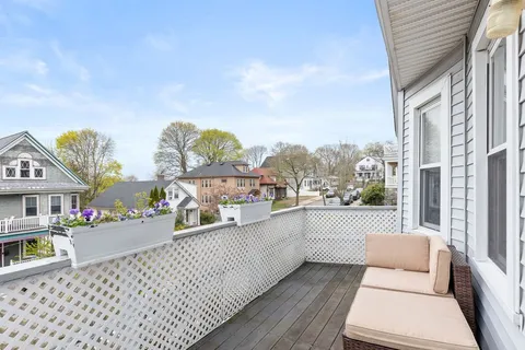 a view of a balcony with chairs