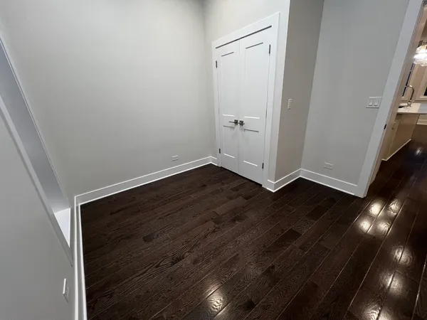 an empty room with wooden floor