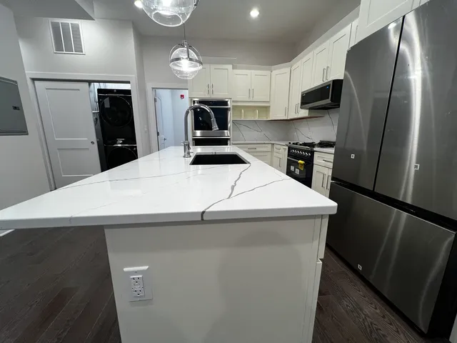 a stove top oven sitting inside of a kitchen