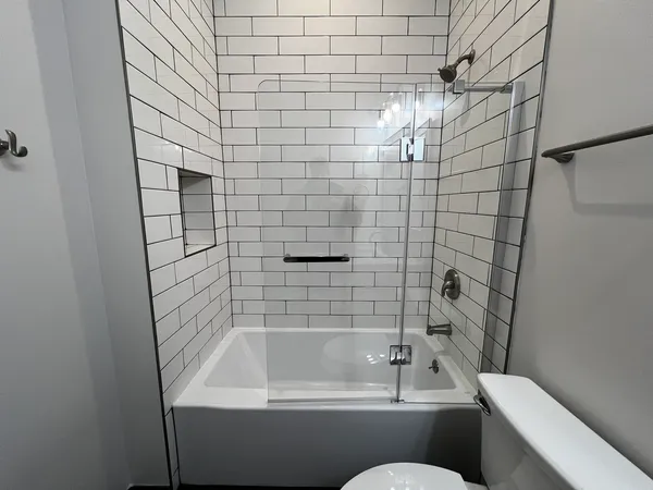 a bathroom with a bathtub and toilet