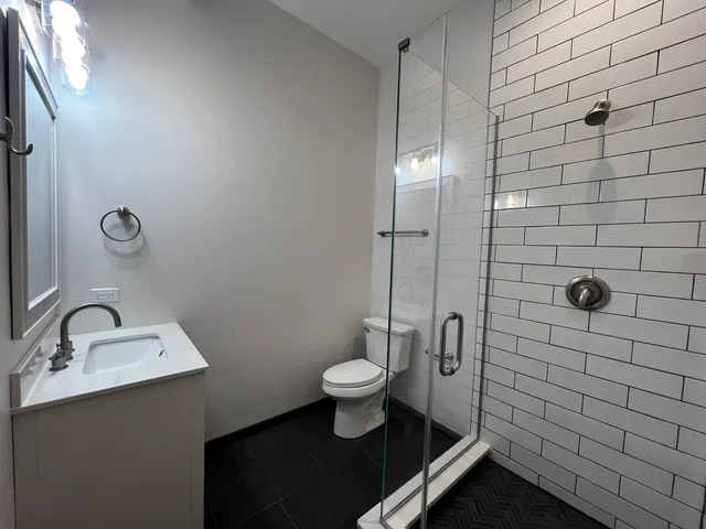 a bathroom with a shower and toilet