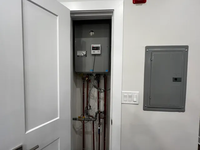 a view of walk in closet with clothes and washer