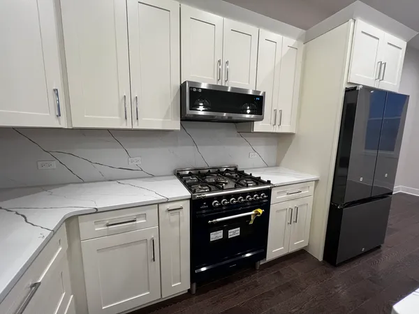 a kitchen with stainless steel appliances white cabinets and a stove