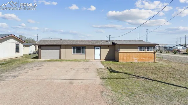 a view of a house with a yard and garage