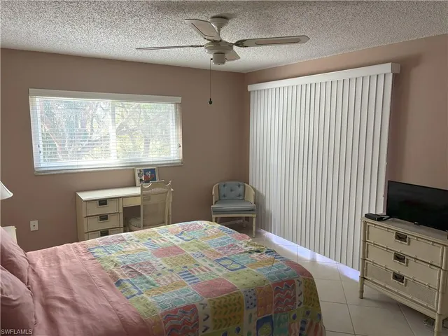 a bedroom with a bed and a tv