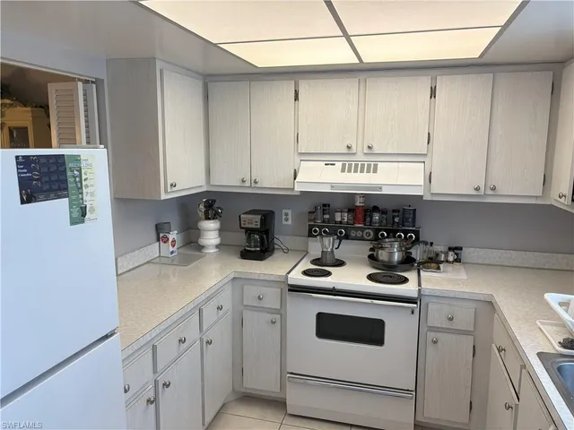 a kitchen with stainless steel appliances granite countertop a sink a stove and cabinets