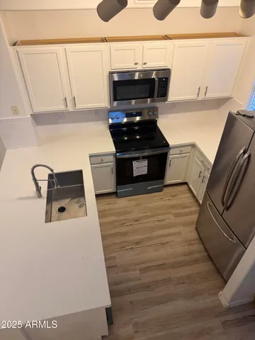 a kitchen with wooden floors and a stove