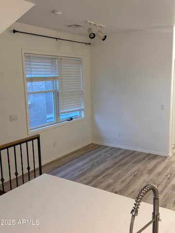 a view of a room with wooden floor and small space