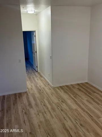 a view of hallway with wooden floor