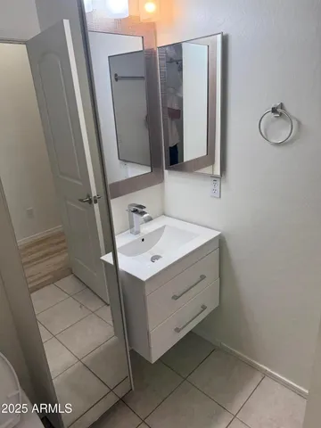 a bathroom with a sink toilet and mirror