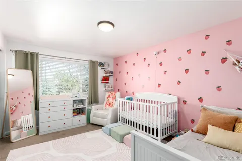 a bedroom with furniture and a baby crib