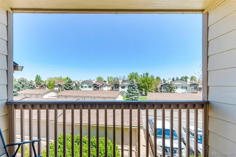 a view of a balcony with wooden fence