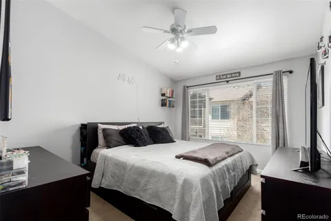 a bedroom with a large bed and a window