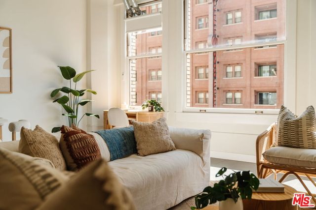 a living room with furniture flowerpot and a window