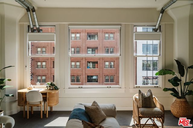 a view of a hallway with wooden floor and glass windows