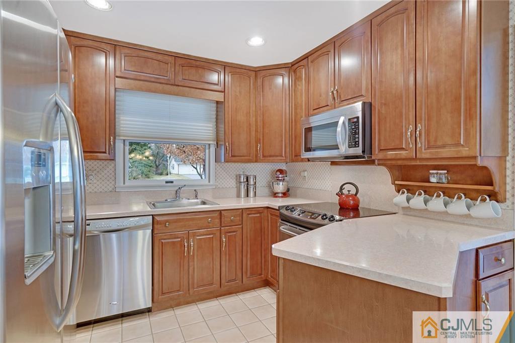 16 Crabtree Road Old Bridge, NJ 07747 - Photo 11 of 25 a kitchen with a sink a stove and cabinets