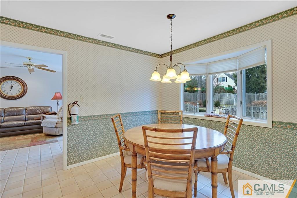 16 Crabtree Road Old Bridge, NJ 07747 - Photo 12 of 25 a dining room with furniture a chandelier and wooden floor