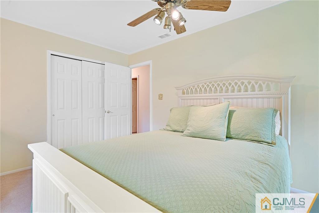 16 Crabtree Road Old Bridge, NJ 07747 - Photo 17 of 25 a bedroom with a bed and a chandelier