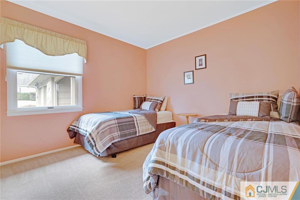 16 Crabtree Road Old Bridge, NJ 07747 - Photo 19 of 25 a bedroom with two beds and a window