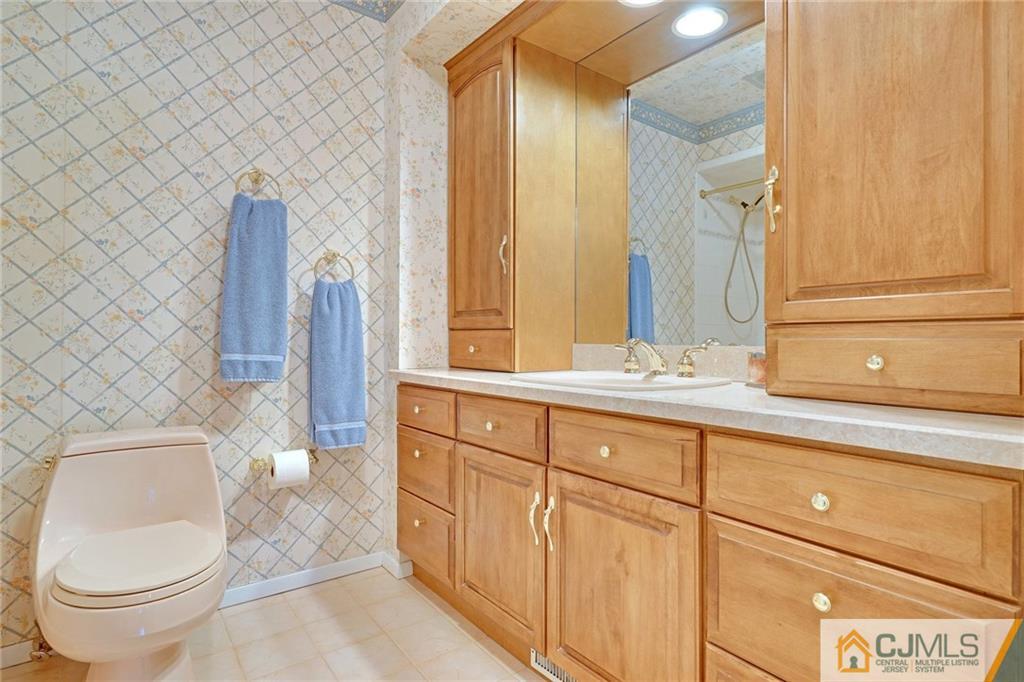 16 Crabtree Road Old Bridge, NJ 07747 - Photo 7 of 25 a bathroom with a toilet a sink and mirror