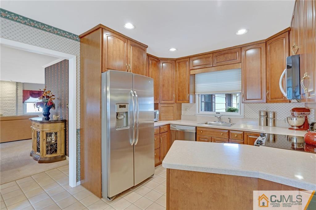 16 Crabtree Road Old Bridge, NJ 07747 - Photo 9 of 25 a kitchen with stainless steel appliances granite countertop a refrigerator and a sink