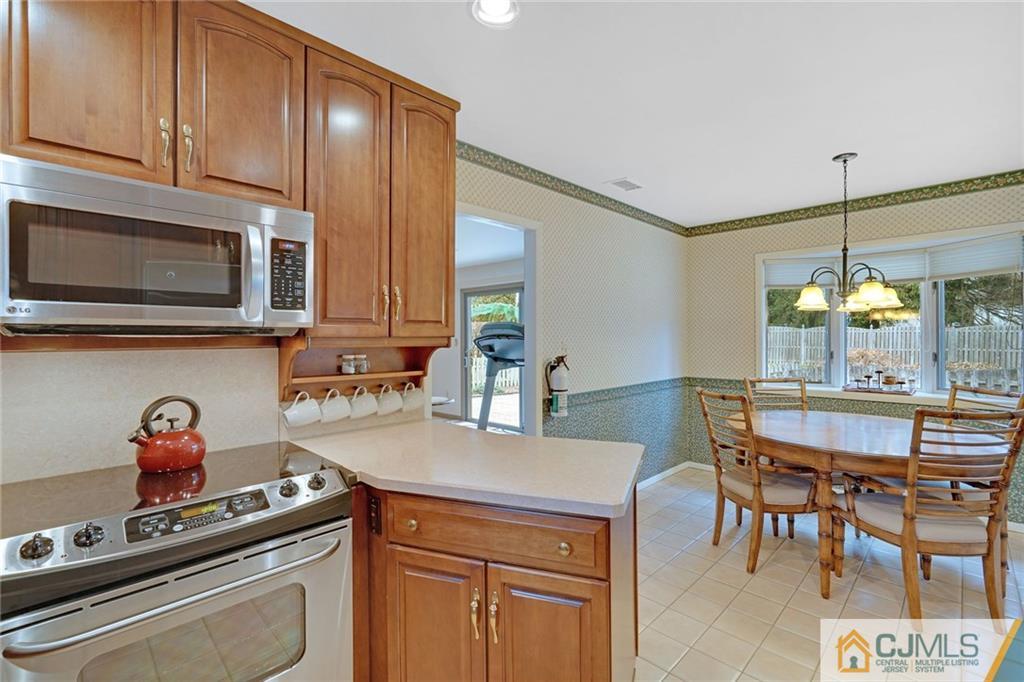 16 Crabtree Road Old Bridge, NJ 07747 - Photo 10 of 25 a kitchen with stainless steel appliances granite countertop a stove and a microwave