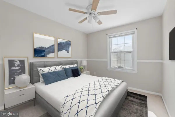 a bedroom with a bed mirror and window