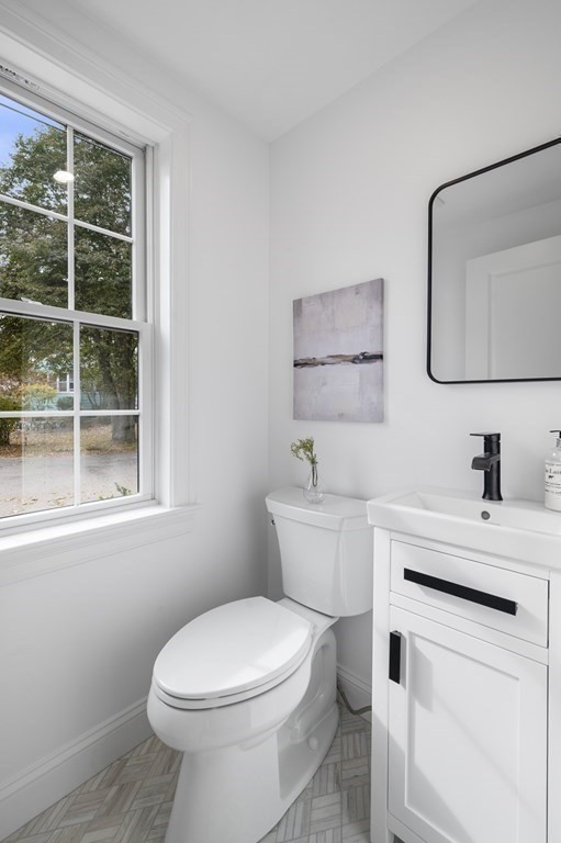 43 Needham Road, Unit 2 Danvers, MA 01923 - Photo 19 of 42 a bathroom with a toilet sink vanity and mirror