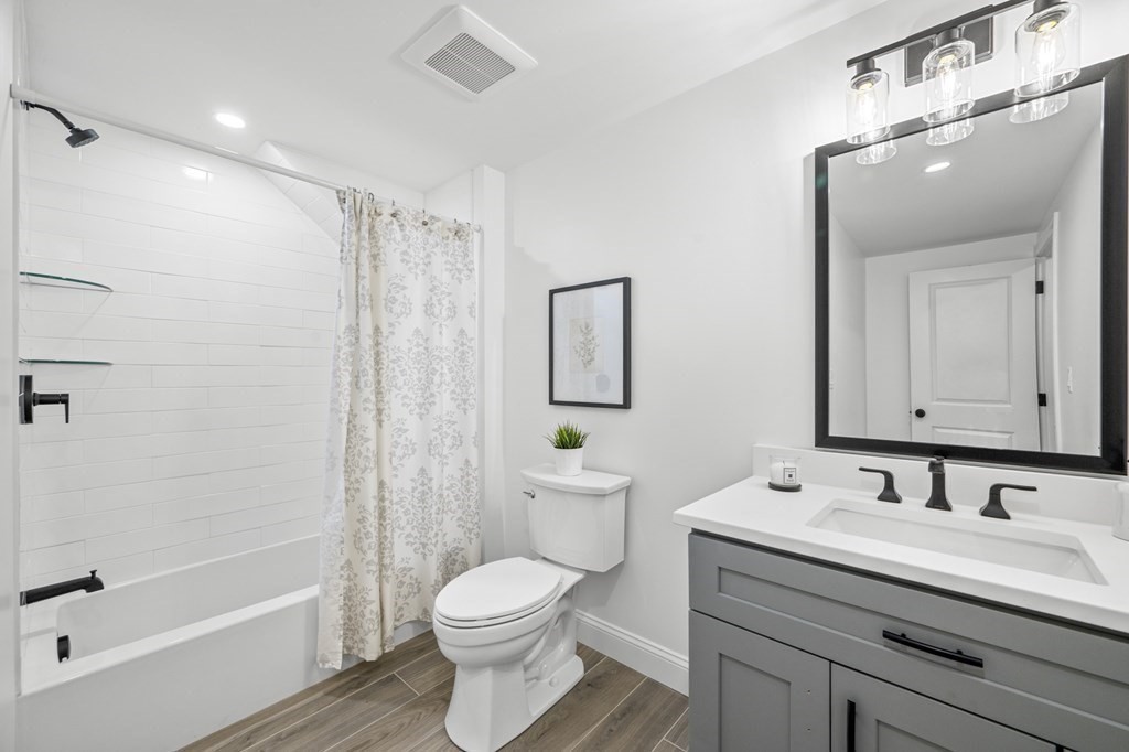 43 Needham Road, Unit 2 Danvers, MA 01923 - Photo 29 of 42 a bathroom with a granite countertop sink a toilet and shower