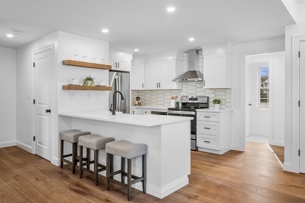 43 Needham Road, Unit 2 Danvers, MA 01923 - Photo 9 of 42 a kitchen with white cabinets and stainless steel appliances