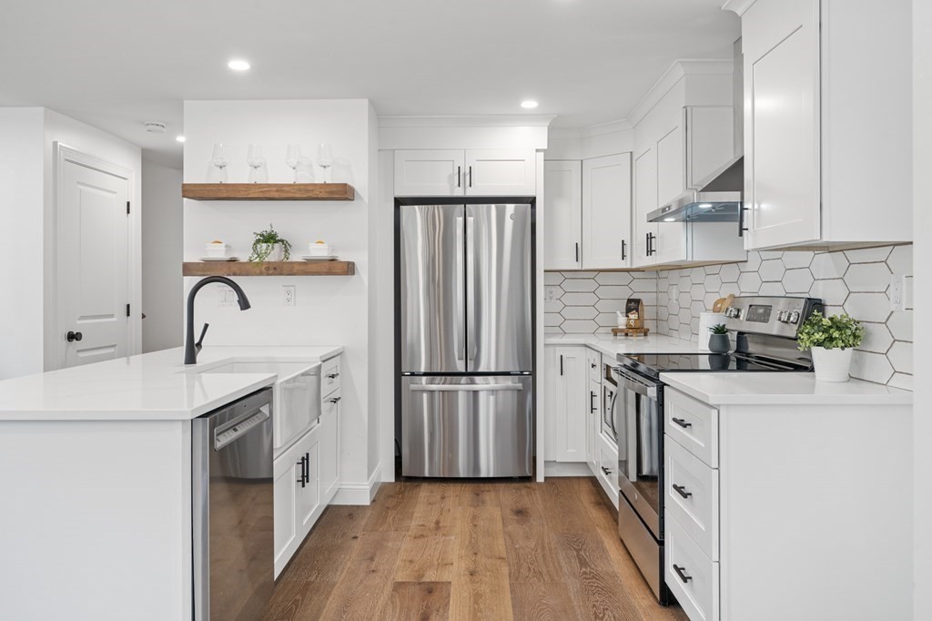 43 Needham Road, Unit 2 Danvers, MA 01923 - Photo 10 of 42 a kitchen with white cabinets sink and stainless steel appliances