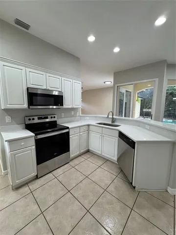 a view of a kitchen with furniture and a window