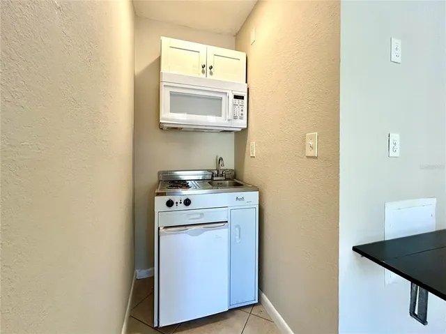 a utility room with a sink dryer and washer