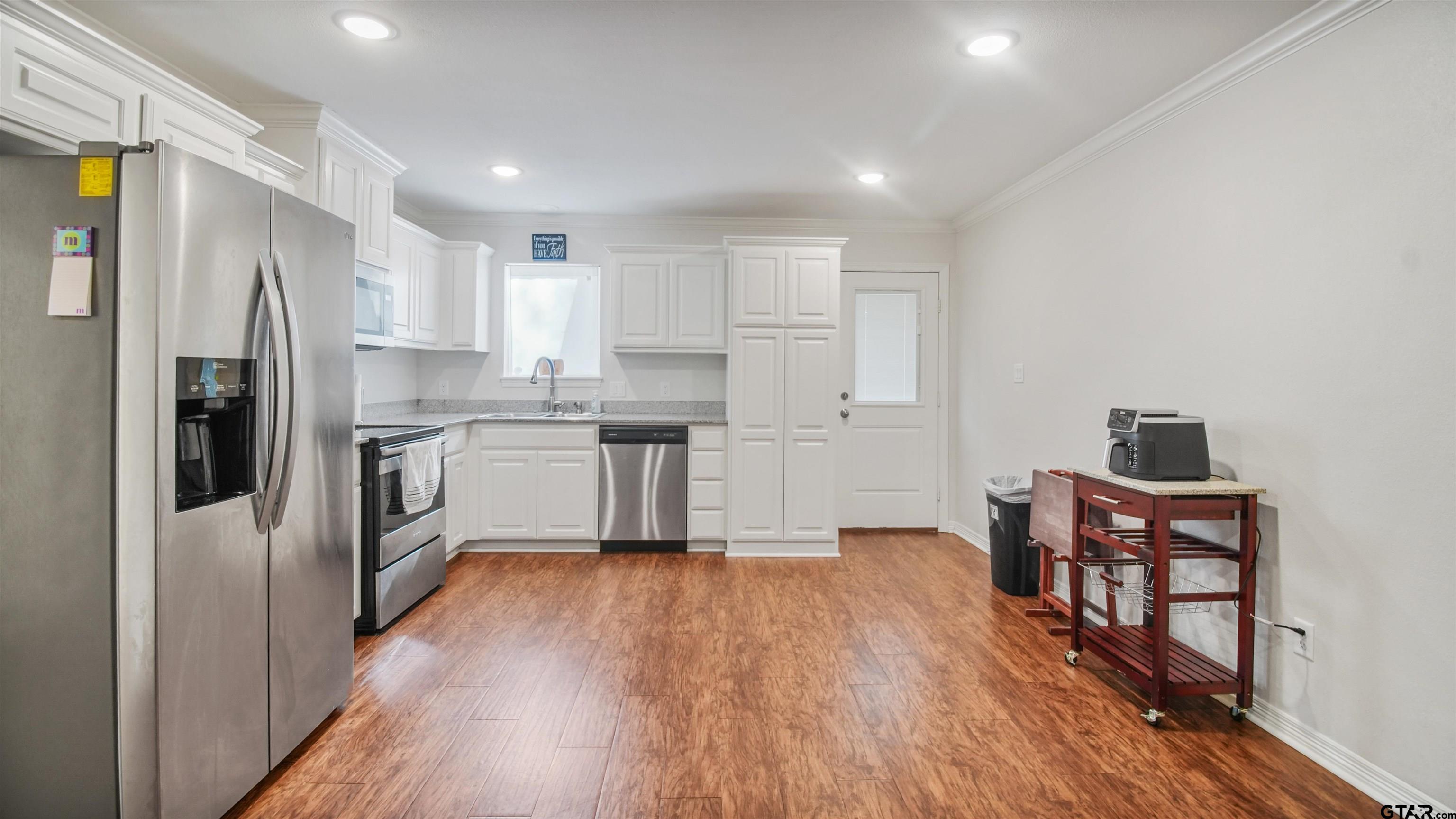 2220 Walton Road Tyler, TX 75701 - Photo 11 of 29 a kitchen with stainless steel appliances a refrigerator and a stove top oven