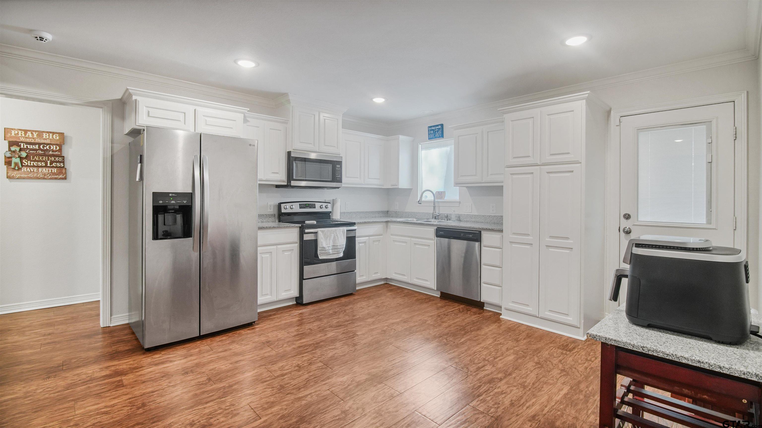 2220 Walton Road Tyler, TX 75701 - Photo 12 of 29 a kitchen with stainless steel appliances a refrigerator and a stove top oven