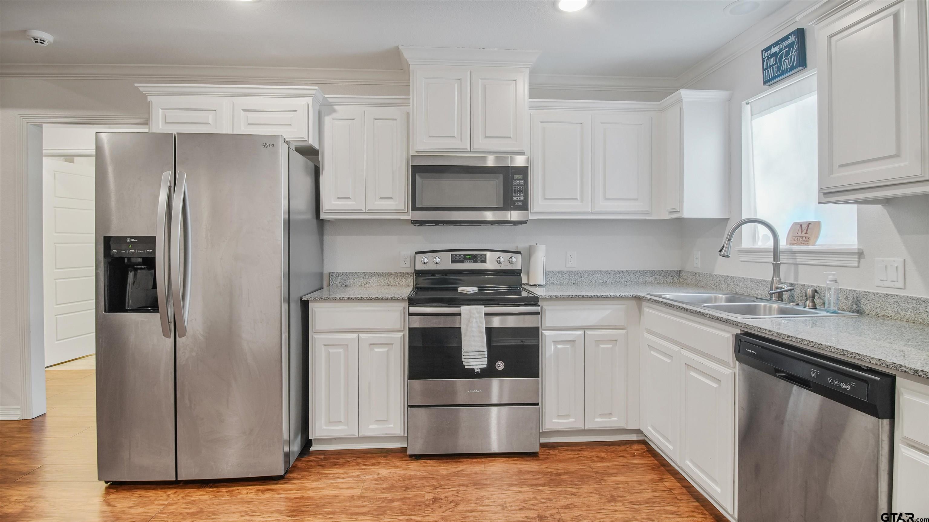 2220 Walton Road Tyler, TX 75701 - Photo 13 of 29 a kitchen with a stove sink and refrigerator