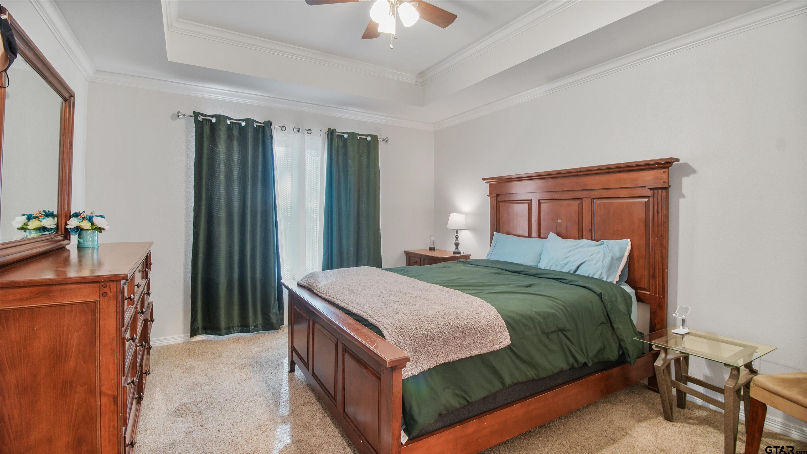 2220 Walton Road Tyler, TX 75701 - Photo 15 of 29 a bedroom with a bed and a chandelier