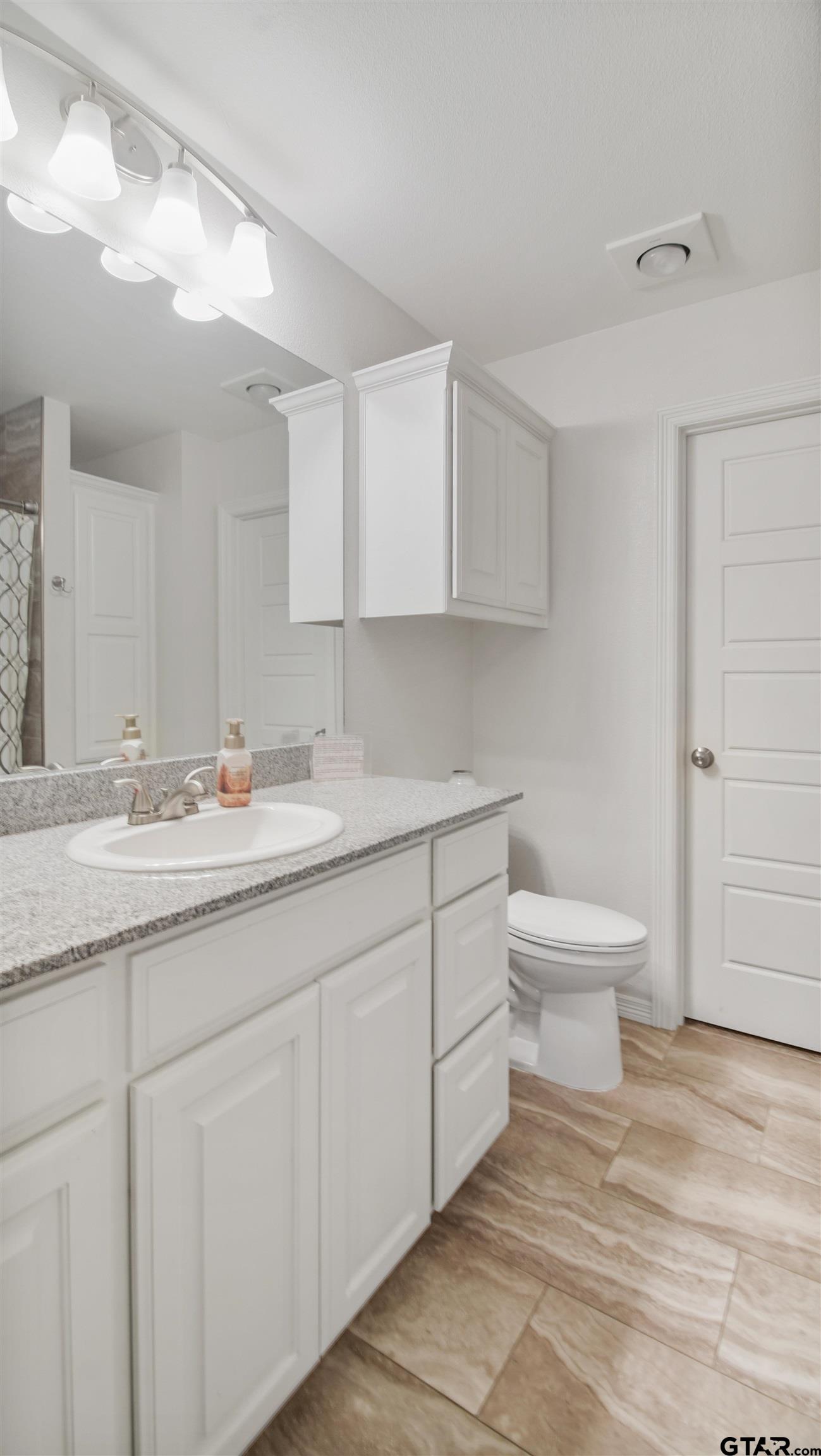2220 Walton Road Tyler, TX 75701 - Photo 18 of 29 a bathroom with a sink toilet and vanity