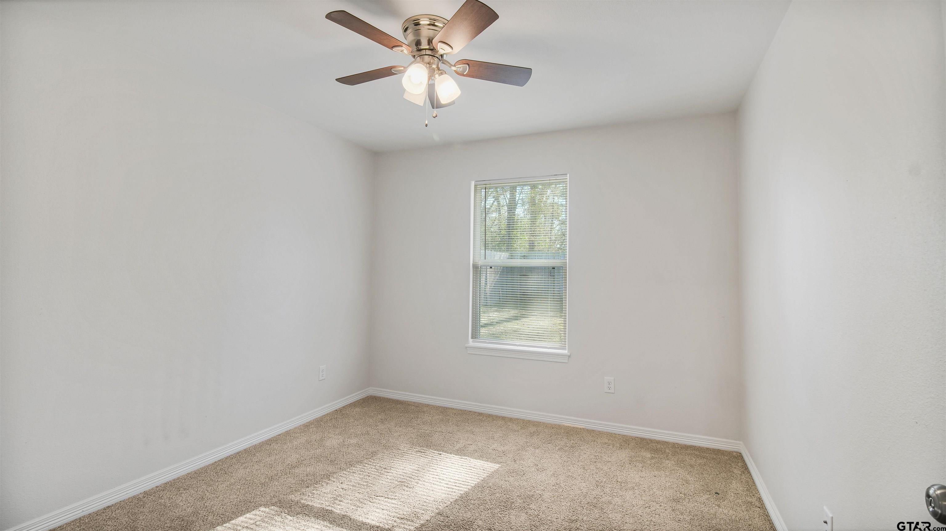 2220 Walton Road Tyler, TX 75701 - Photo 21 of 29 an empty room with windows and fan