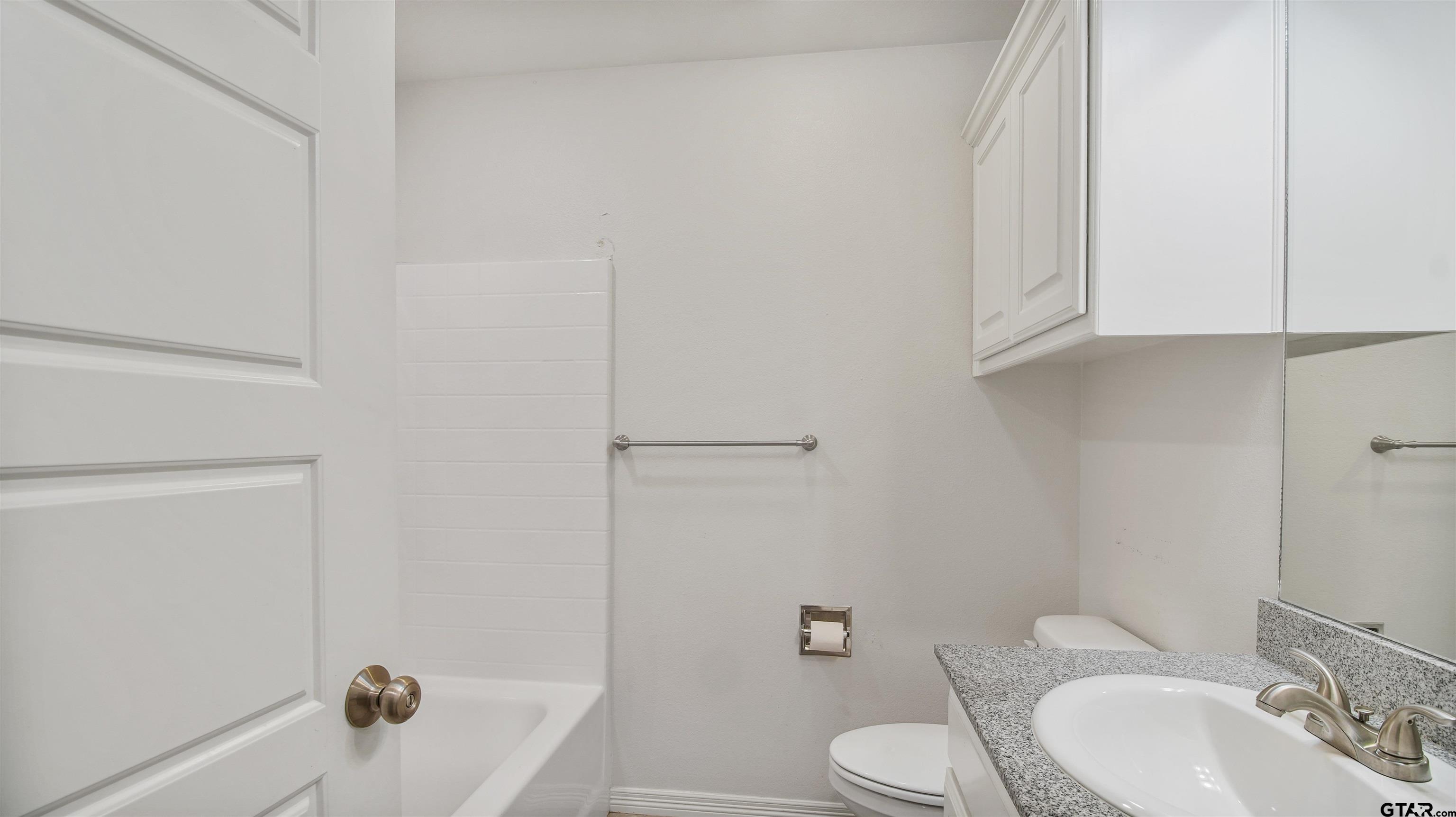 2220 Walton Road Tyler, TX 75701 - Photo 23 of 29 a bathroom with a sink toilet and shower